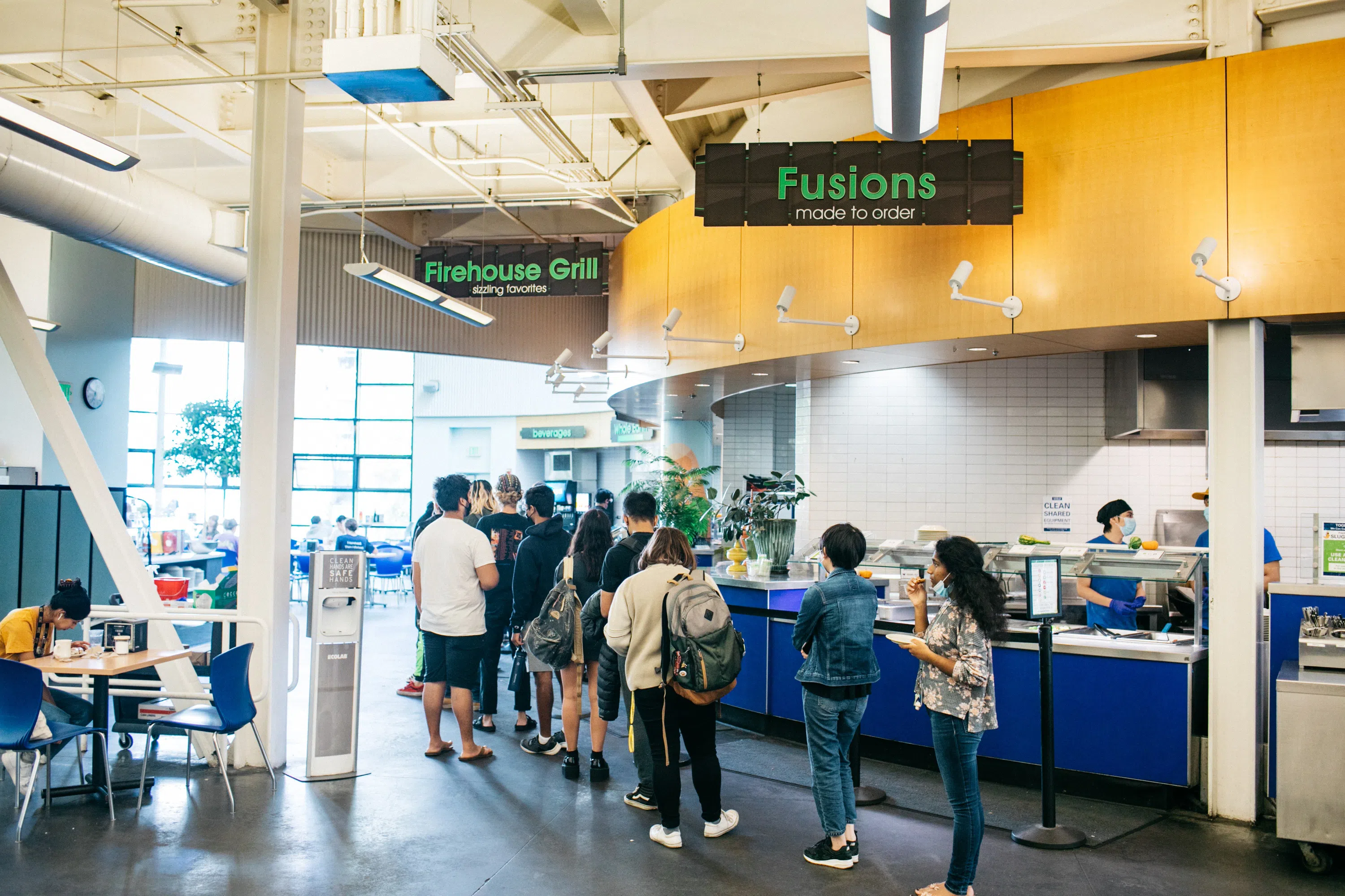 Students wait in line for food