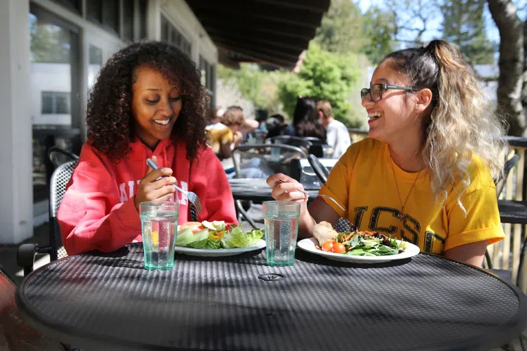 Students eat together on the patio