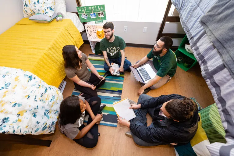 Students conversing in the Village