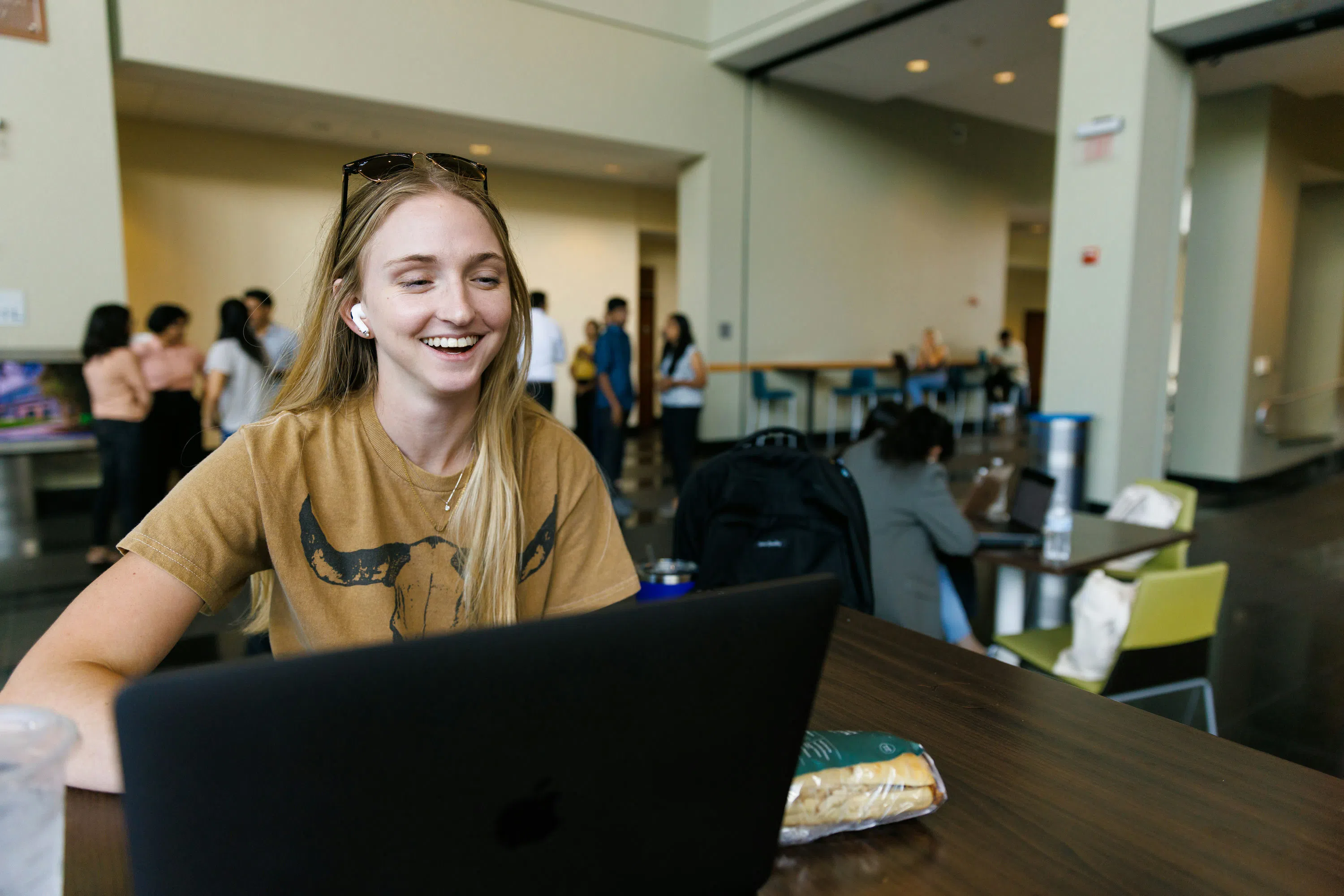 Student using a laptop in the Muma College of Business.