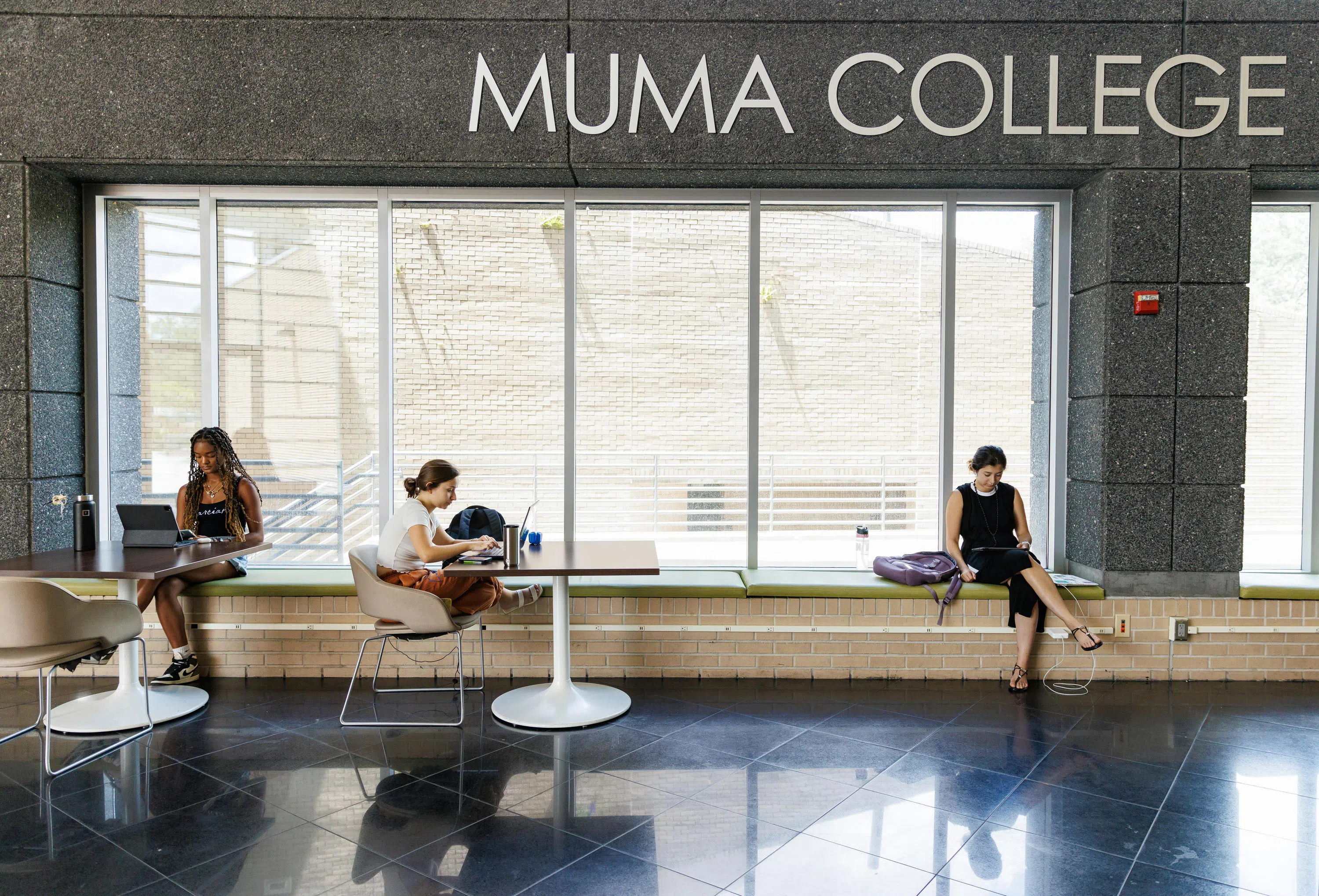 Students studying in the Muma College of Business atrium.