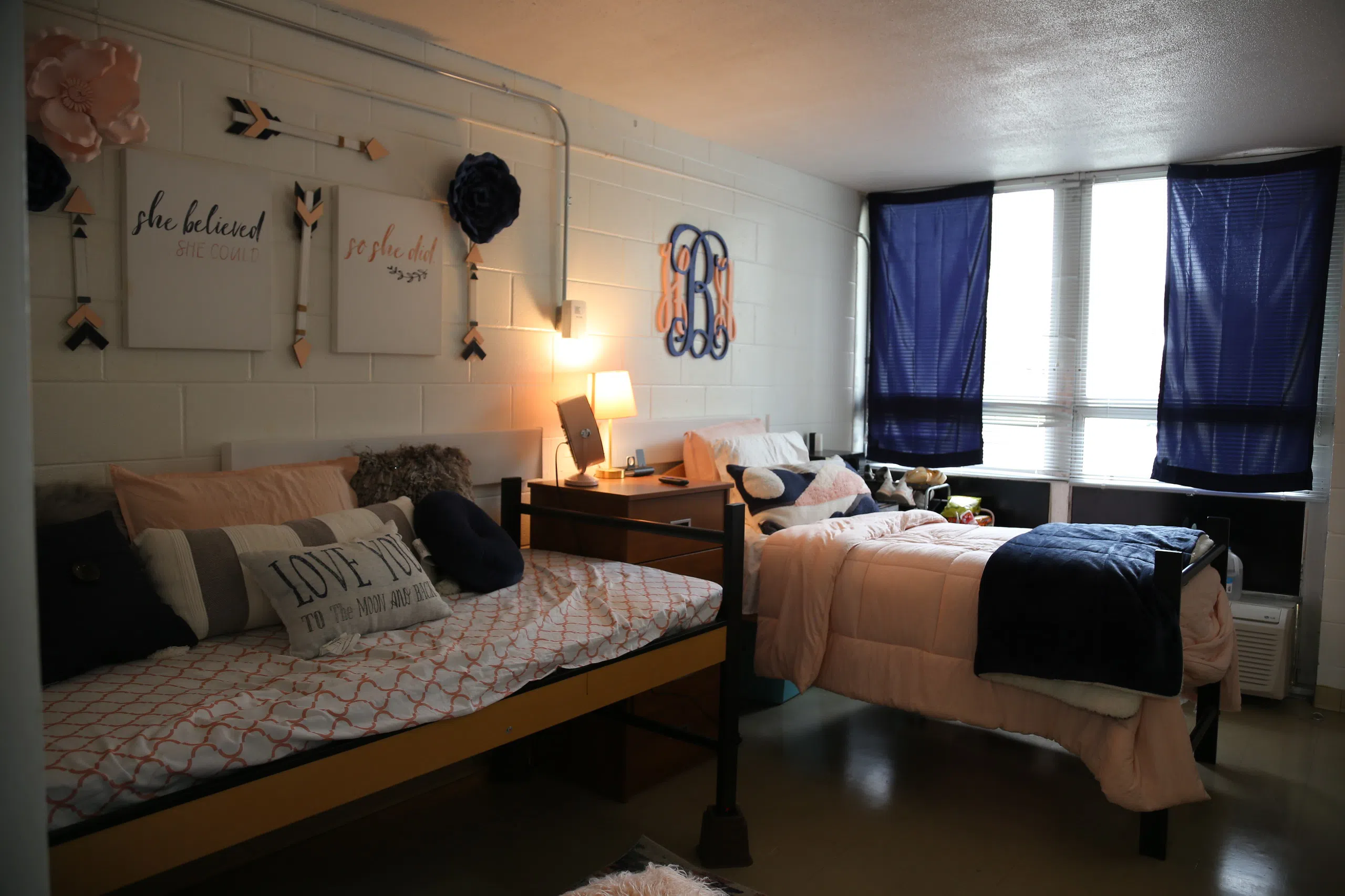 Dorm room interior with bed and window. 