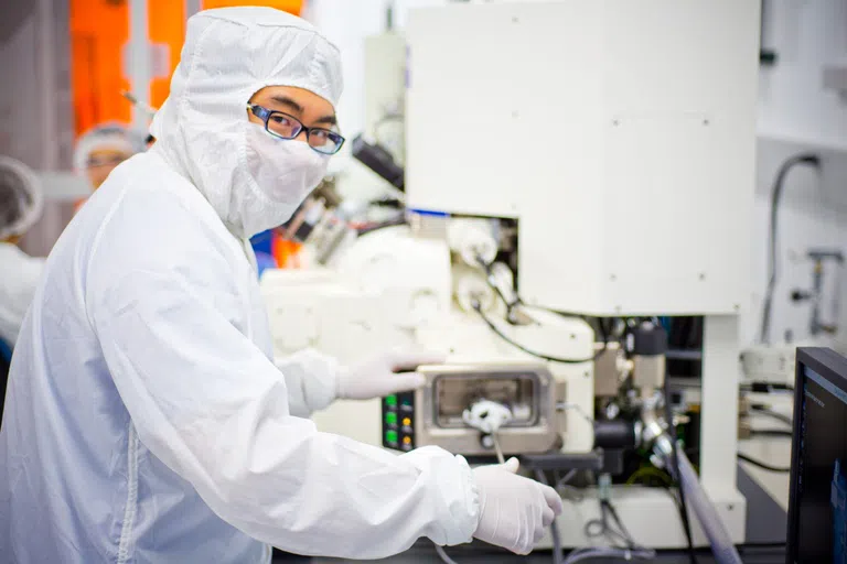 Photo of student in clean room at the University at Buffalo.