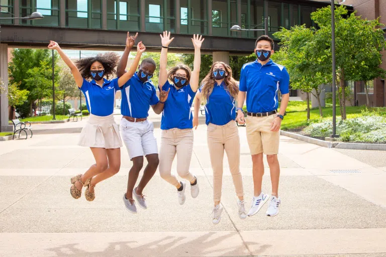 Group of students jumping in the air and cheering