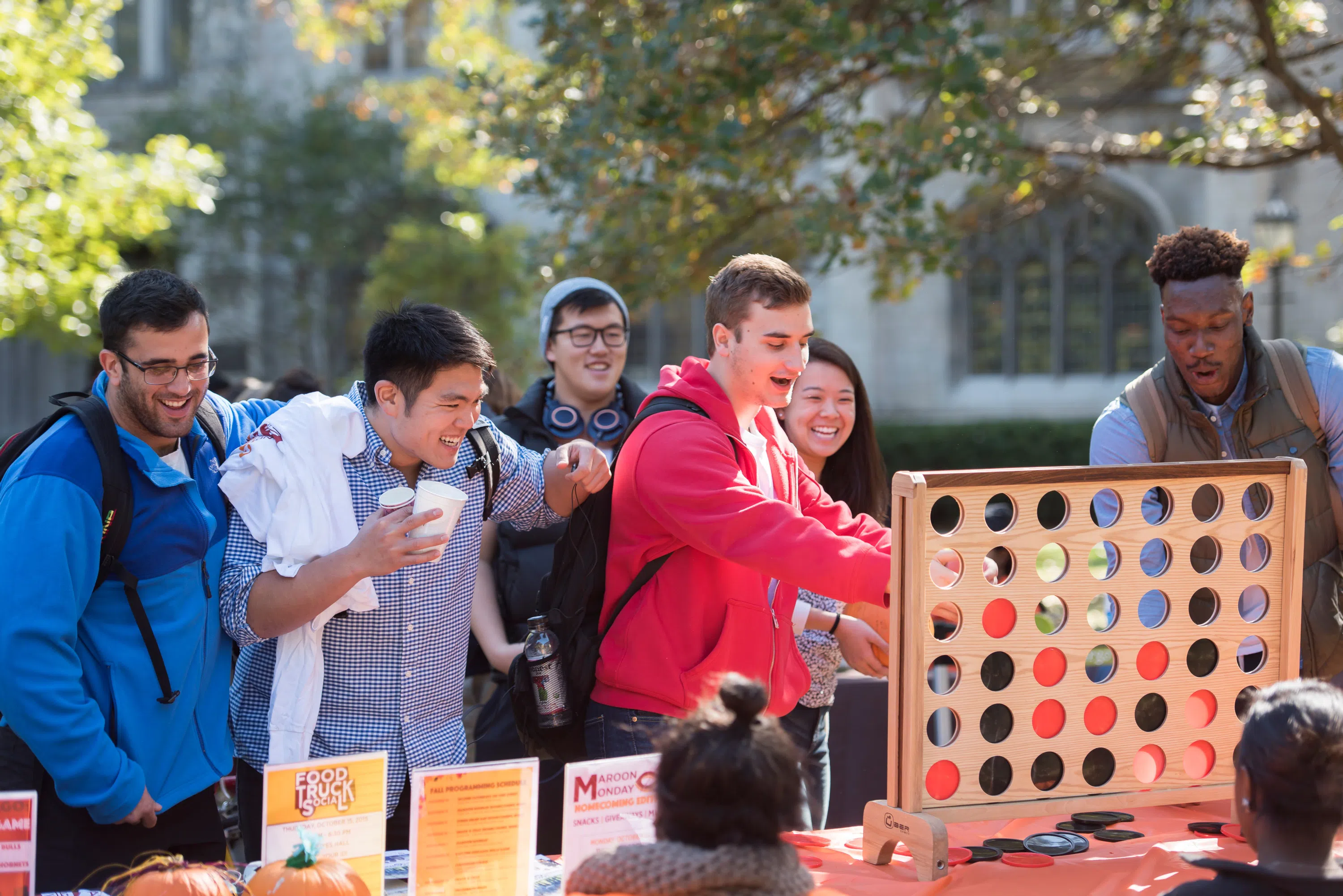 a group of students play a large game of connect 4 on the quad
