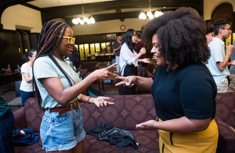 two students play a game of rock paper scissors