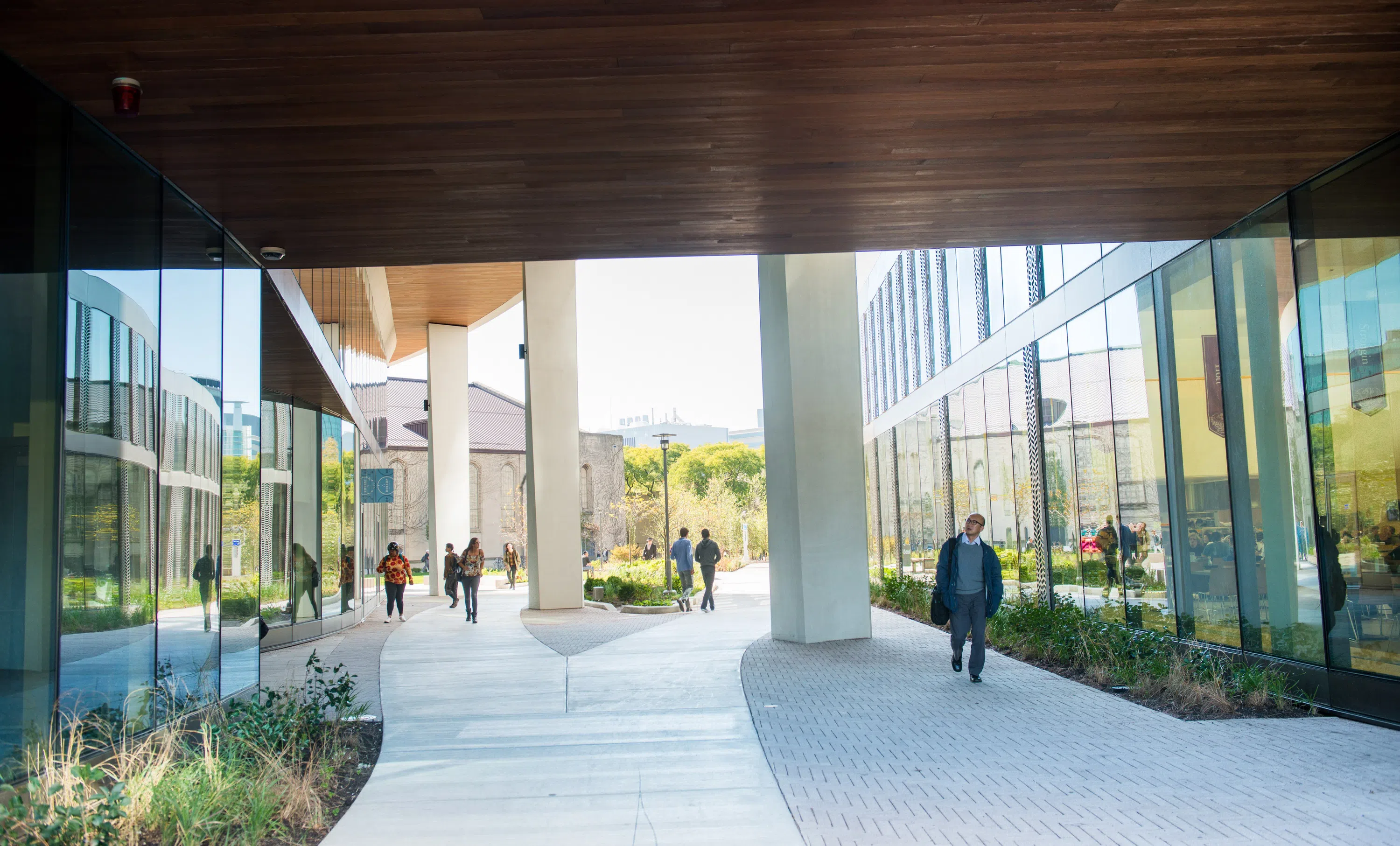 an outdoor walkway through the residential building courtyard