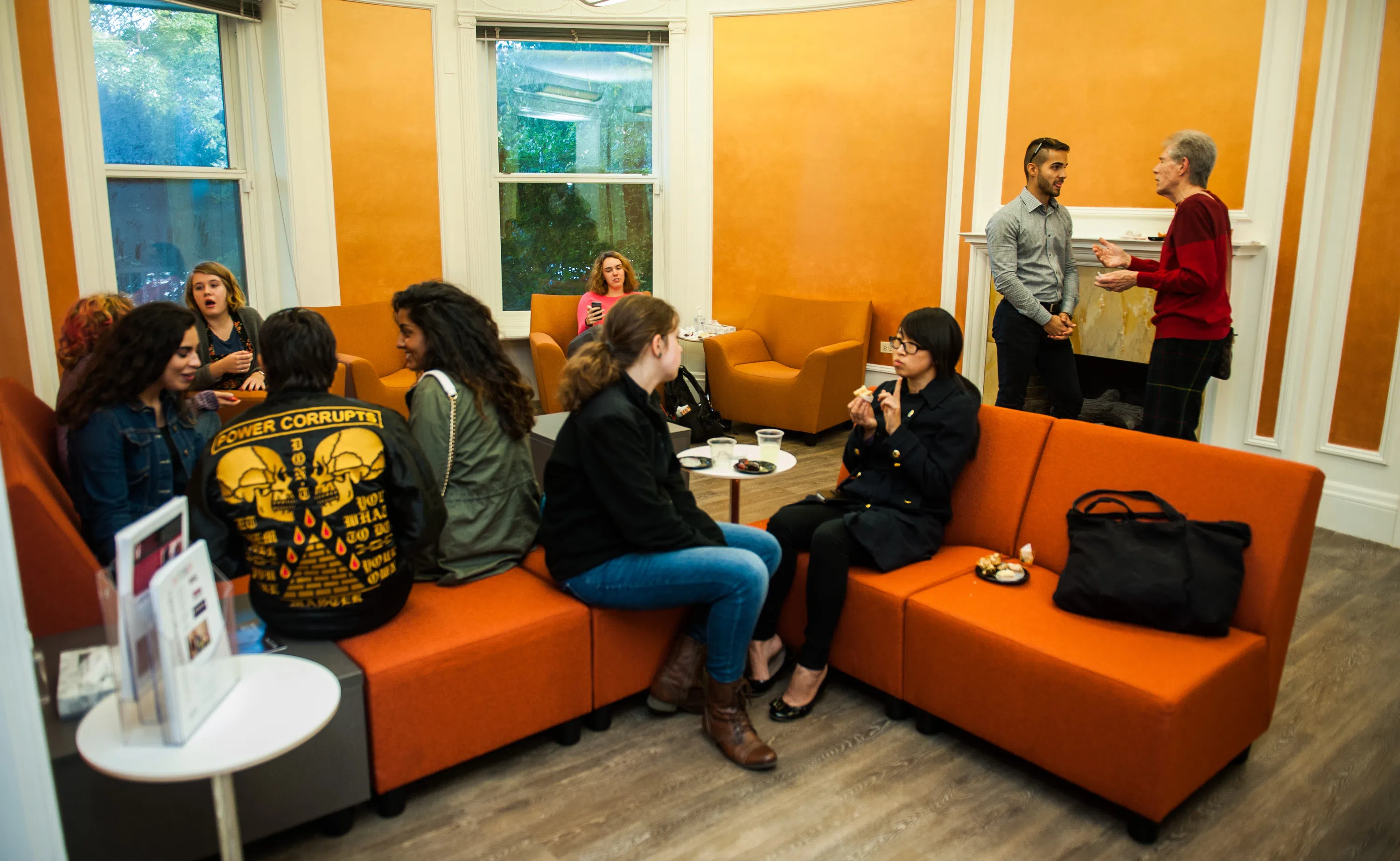 Students sit on orange couches inside the CII