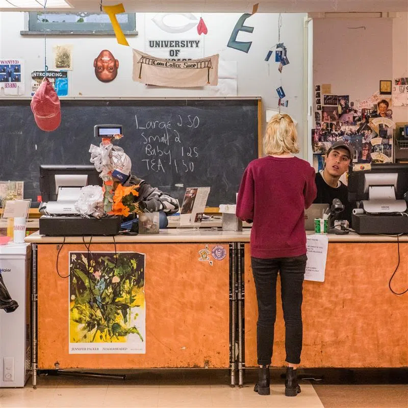 A woman stands at the checkout counter of Cobb Cafe