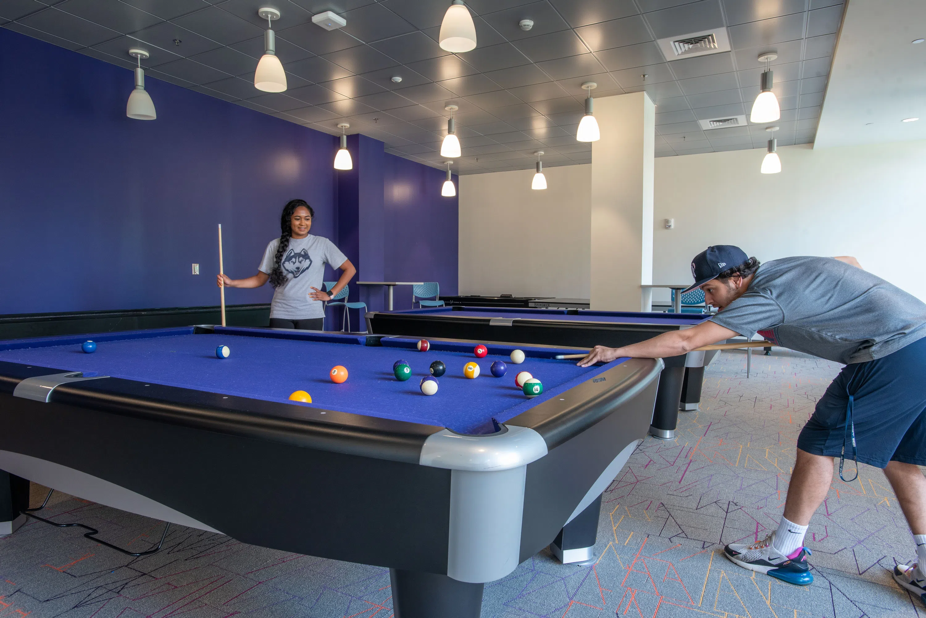 students playing pool in a residence hall game room