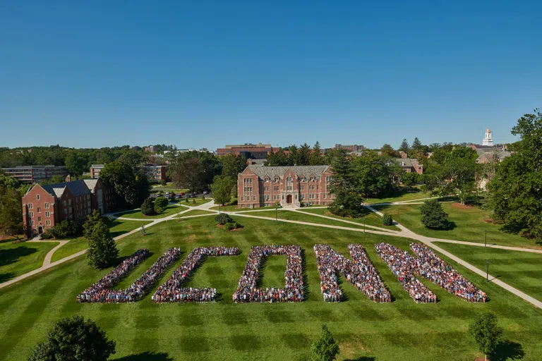 Students lining up to spell U-C-O-N-N for a class photo, one of the university's many traditions