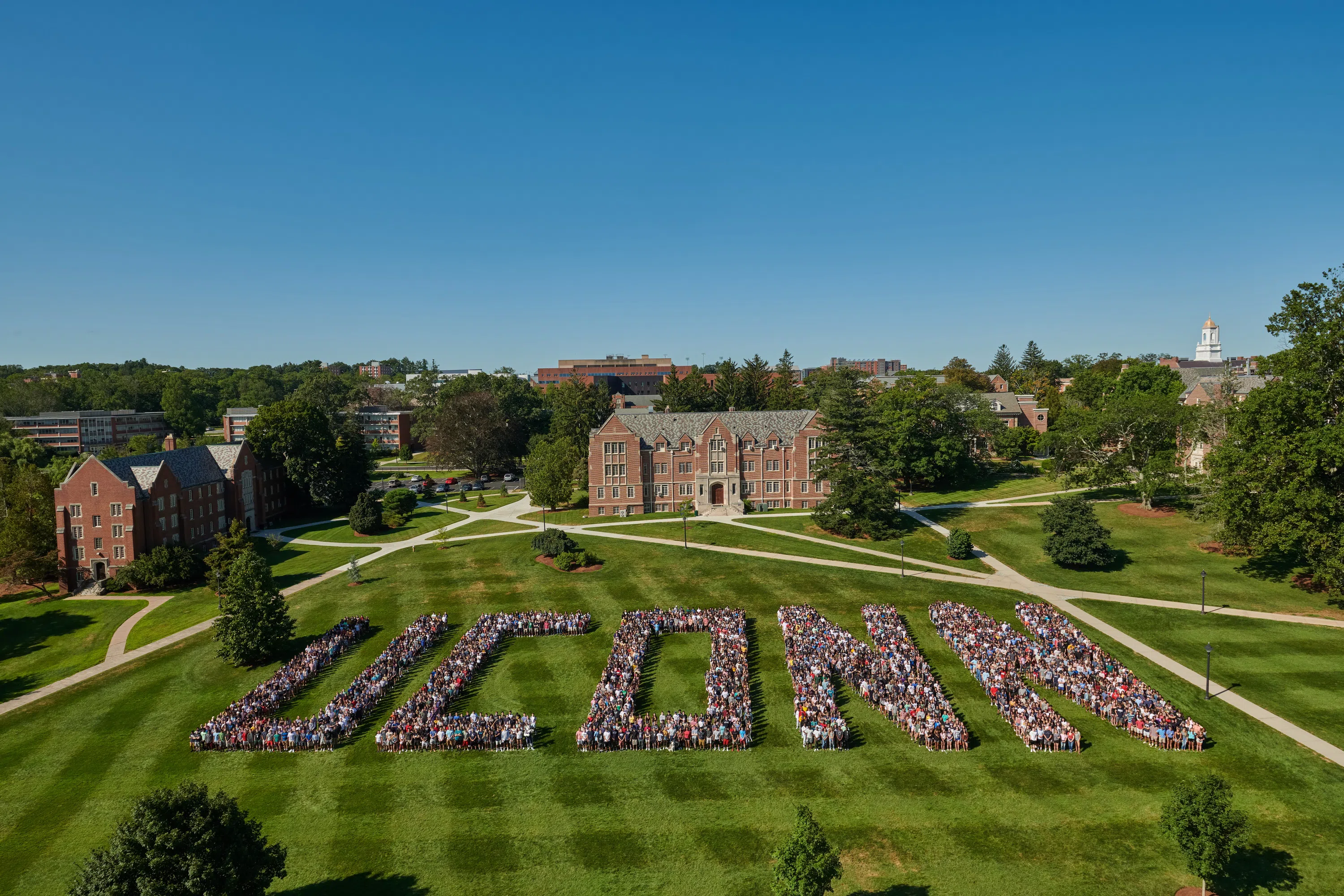Students lining up to spell U-C-O-N-N for a class photo, one of the university's many traditions