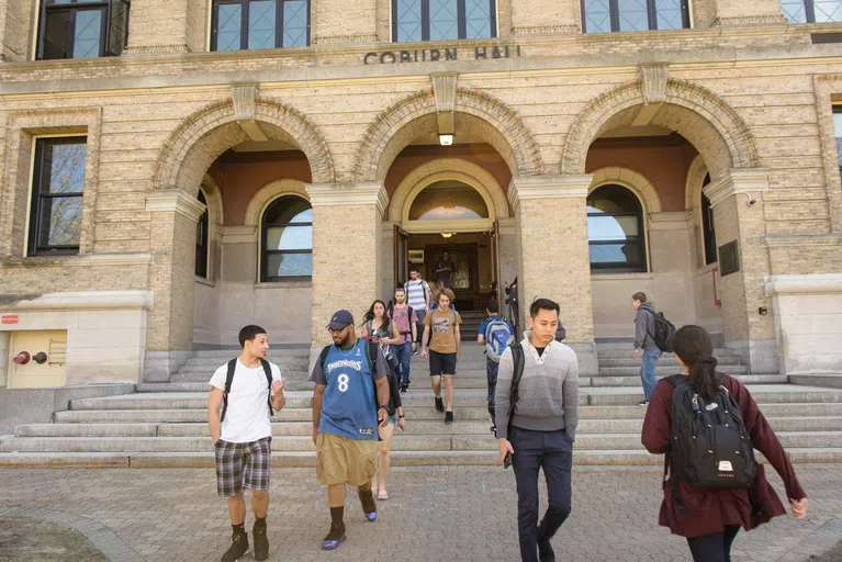 Students walking in front of the exterior of Coburn Hall at UMass Lowell