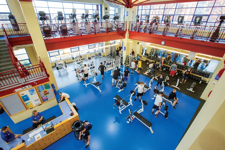 Students using exercise equipment in the UMass Lowell Campus Recreation Center