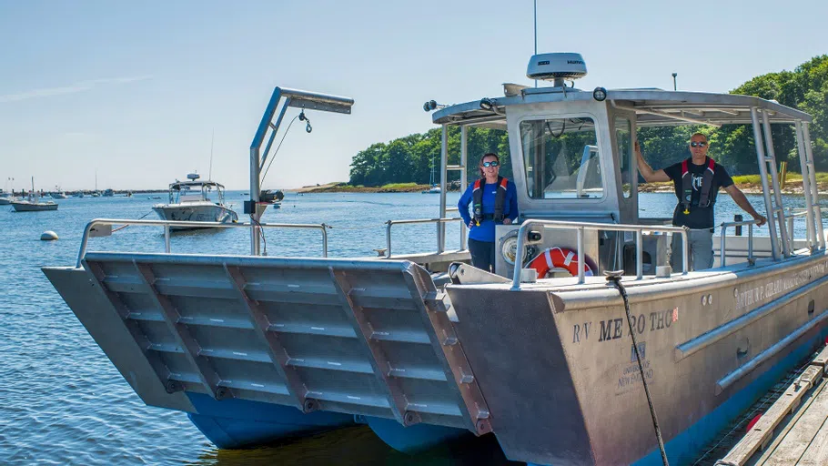 Two people aboard the R/V Sakohki research vessel