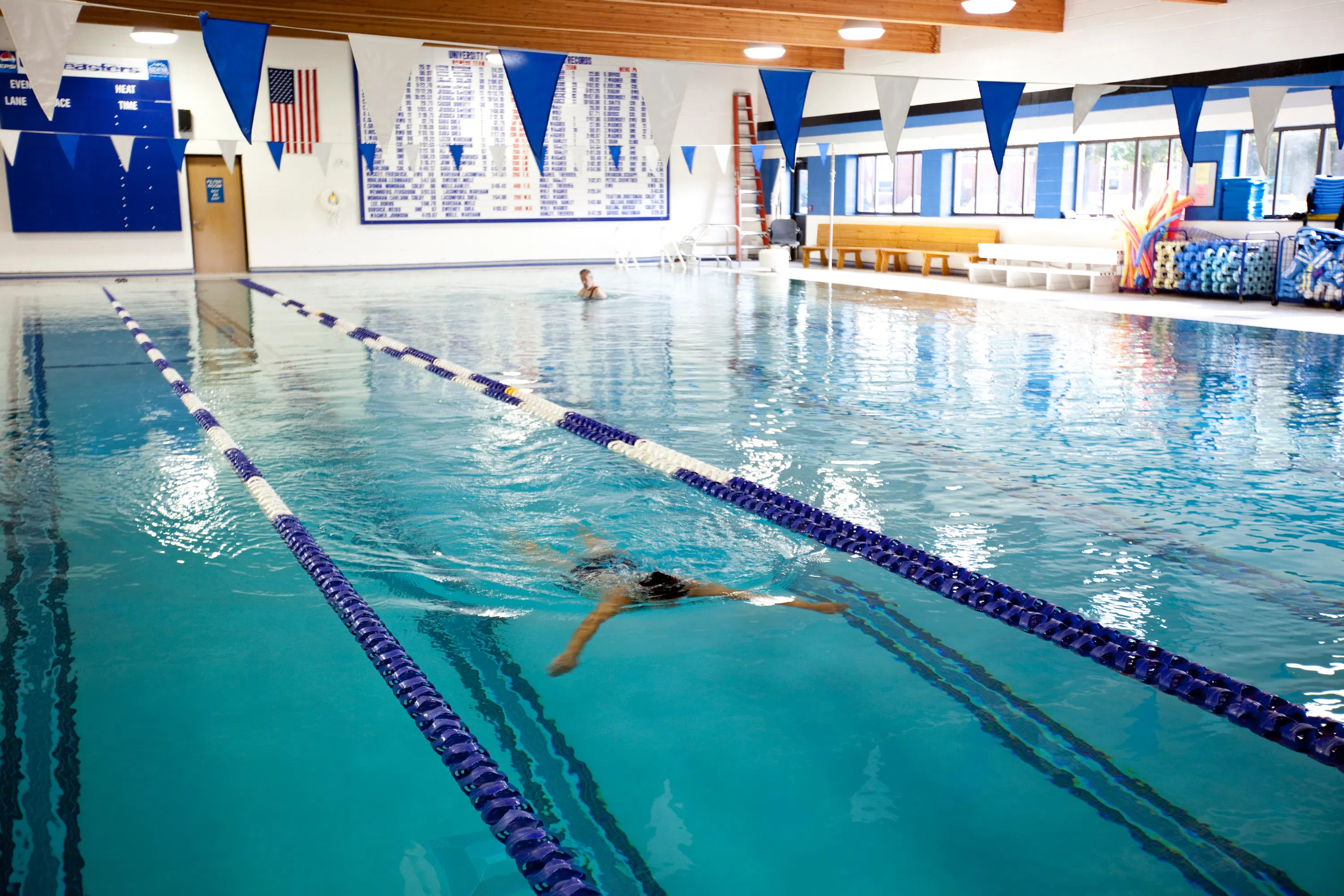 Person swims in a large indoor pool