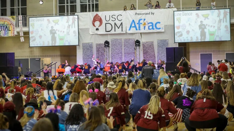 Students participate in the daylong Dance Marathon event, raise hundreds of thousands of dollars annually for a local children’s hospital.