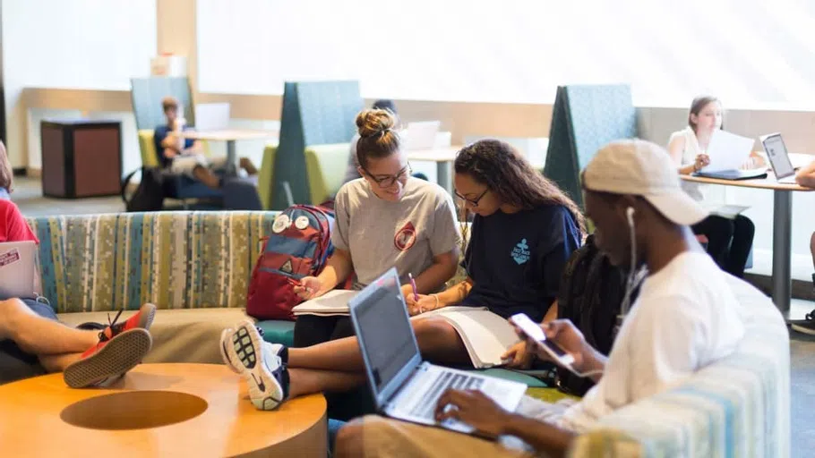 Two students studying together on a couch