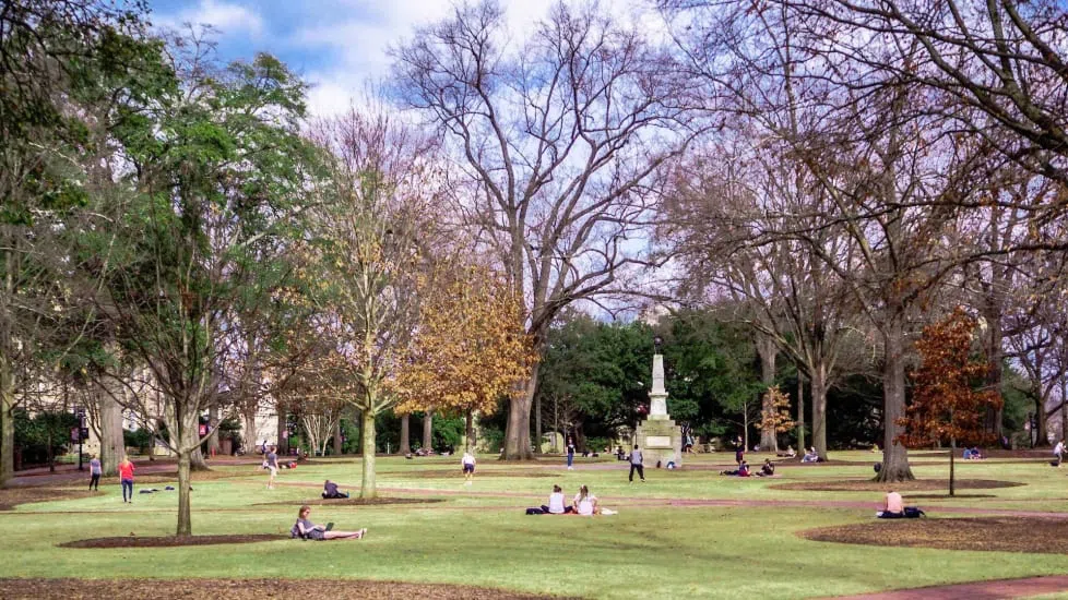 Wide shot of the Horseshoe, showing the Maxcy Monument in the center and students sitting on the grass