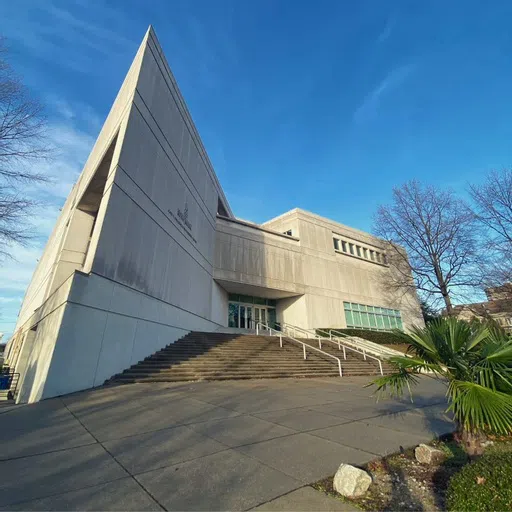 View of the gray stone Swearingen Engineering Center on a beautiful blue-sky day