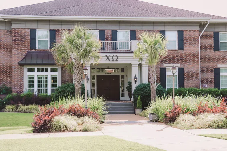 View of the front of the Chi Omega House during the day