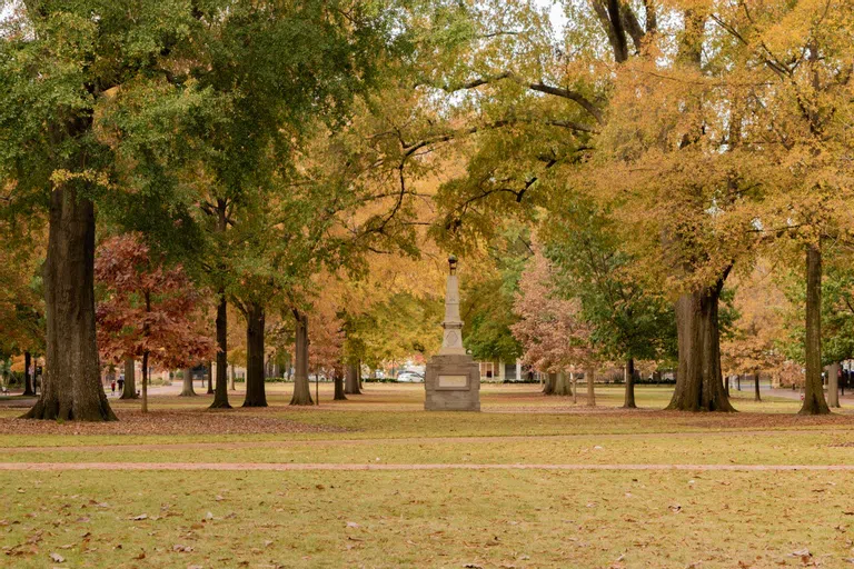 Maxcy Monument on the Horseshoe with fall leaves in the background.