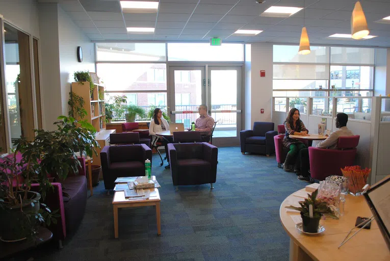 Students meeting with career counselors at a table and set of chairs.