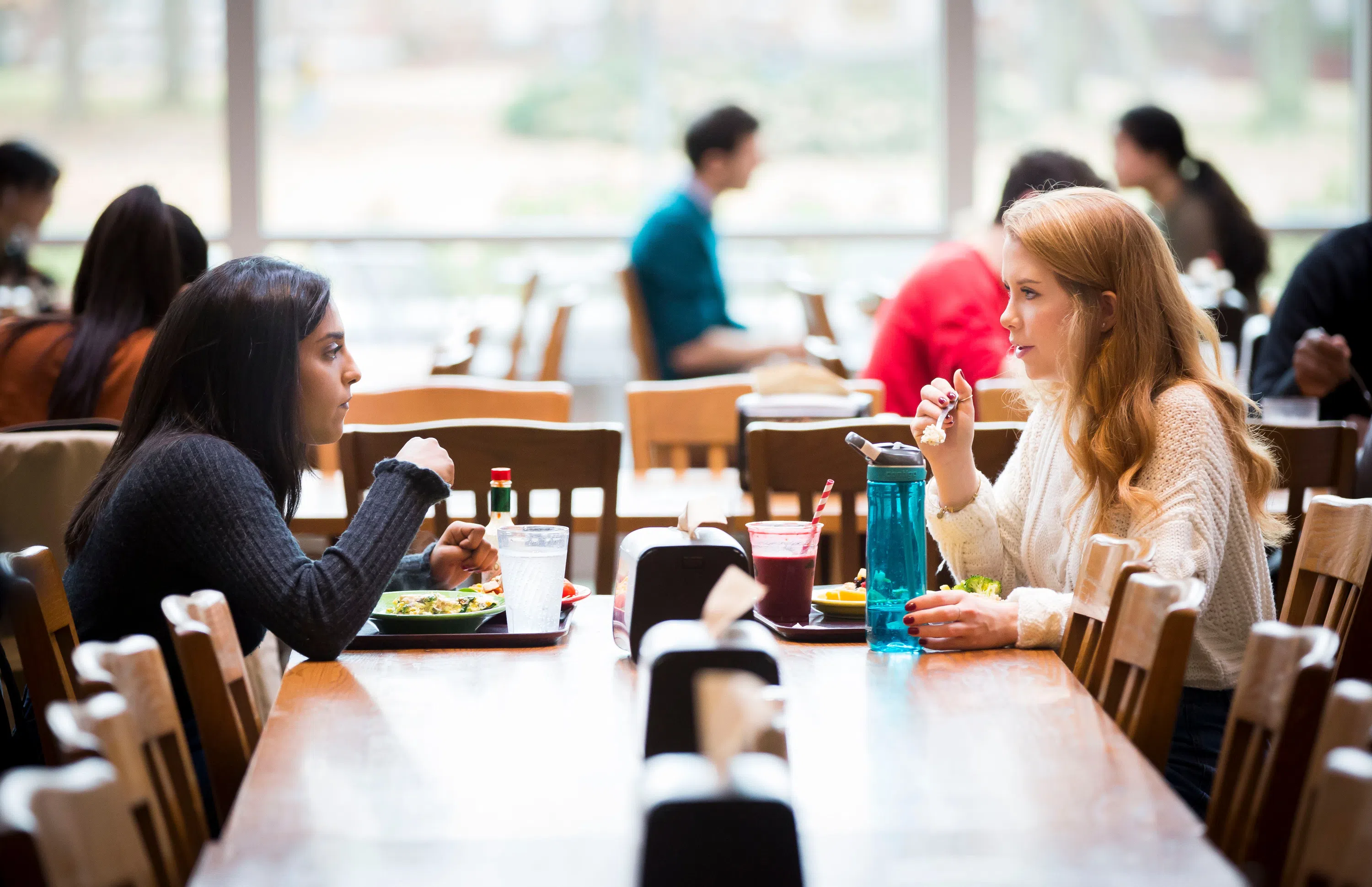 two students enjoying a meal at The Commons Dining Hall