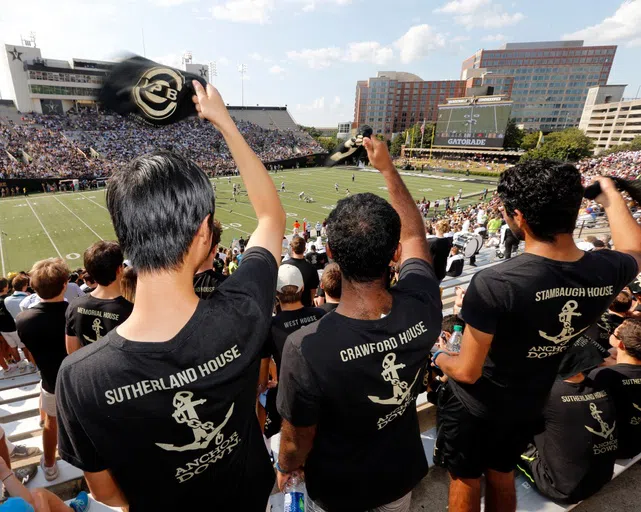 3 students cheer in the stands at Vanderbilt Stadium