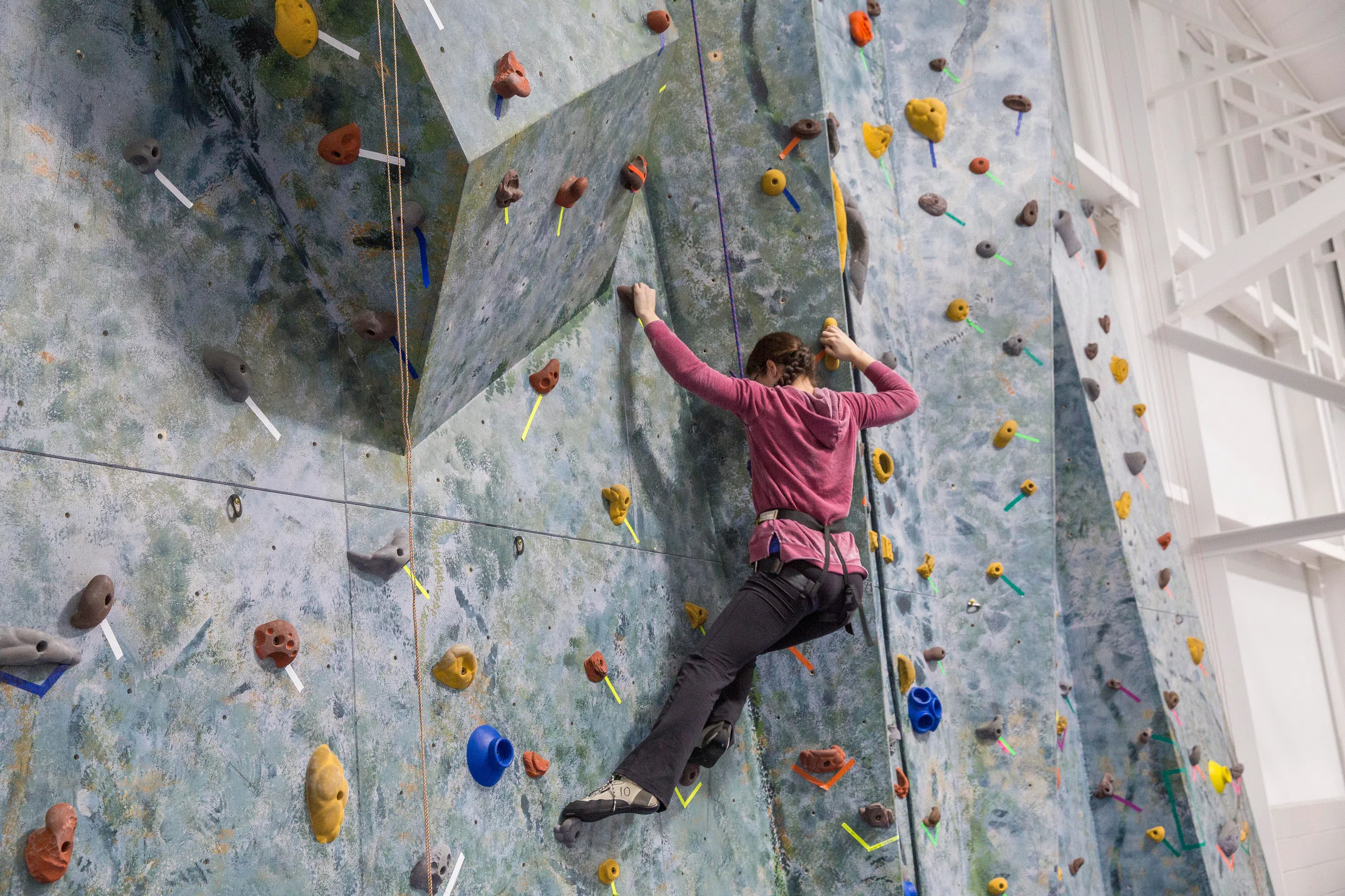 Wellesley student climbing rock wall