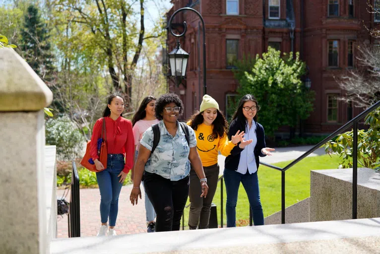 students walk up stairs on Wellesley's iconic campus