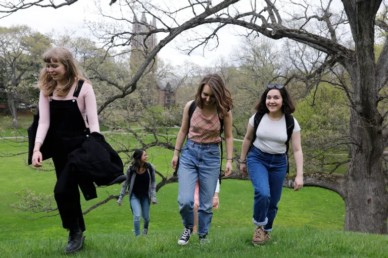 Wellesley students walking up Sev Hill