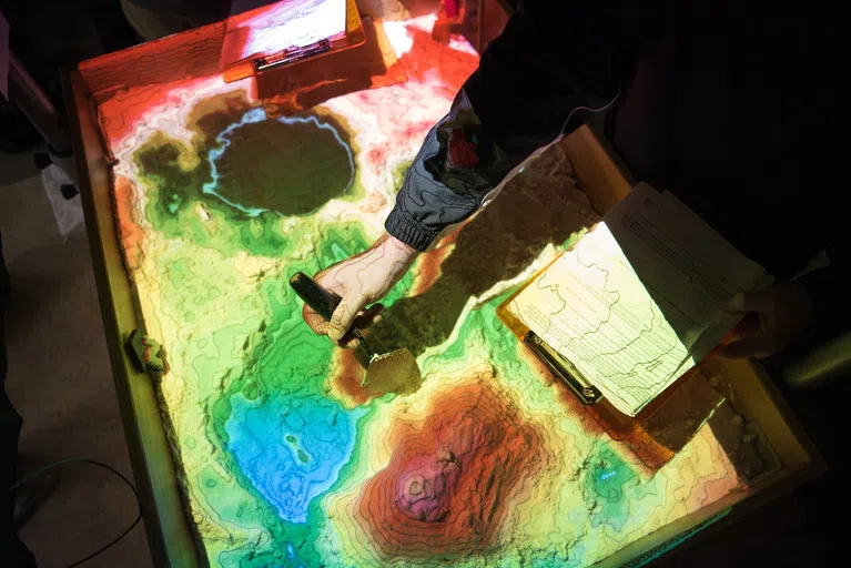 Students in geology classes get to partake in learning with the Augmented Reality Sandbox to create terrains of their own!