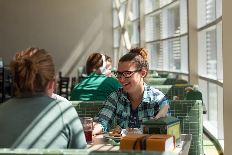 Take a seat and share your meal along the wall of windows in West Dining Center!